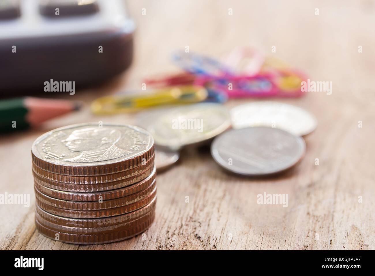 Close up stack of assorted coins on the wooden table Stock Photo - Alamy
