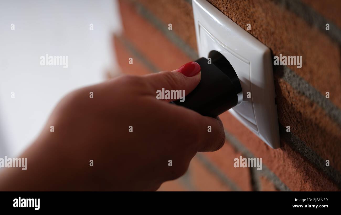 Inserting electrical power cord socket hi-res stock photography and ...