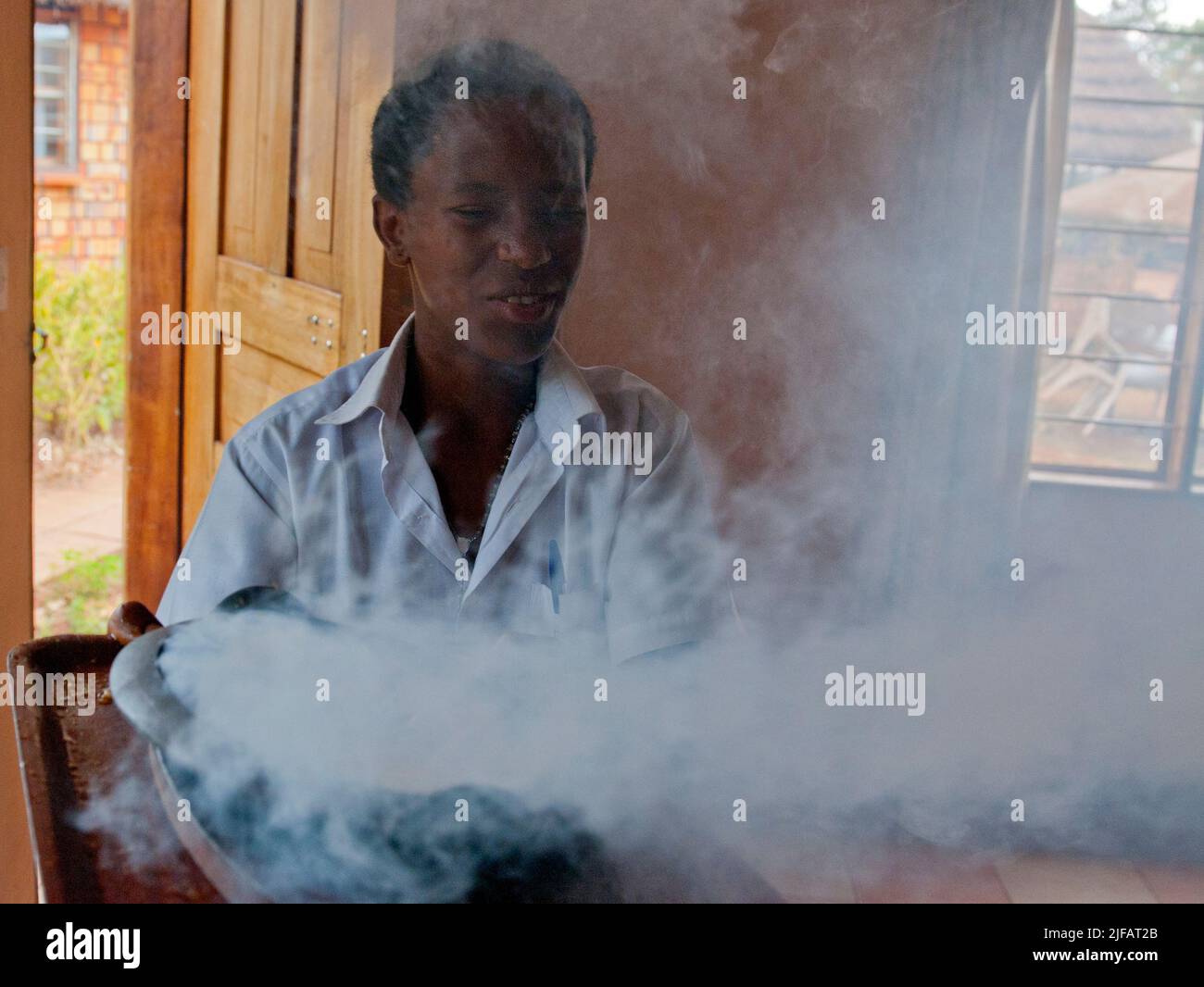 Serving Sizzeling Beef in Masindi, Uganda. Stock Photo