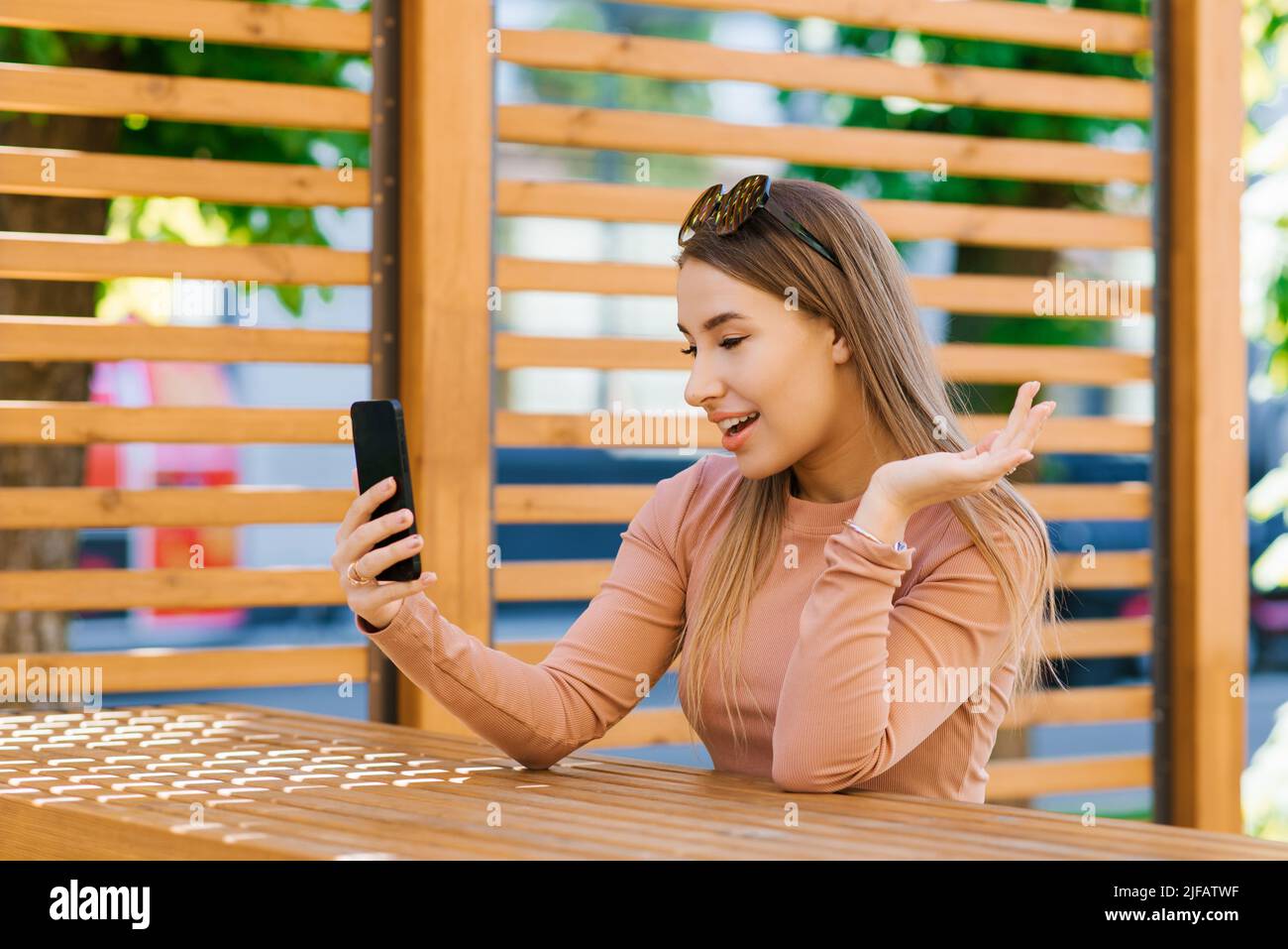 Happy female hold phone chat in social network read good news, shopping via  online store app at home Stock Photo by StudioVK