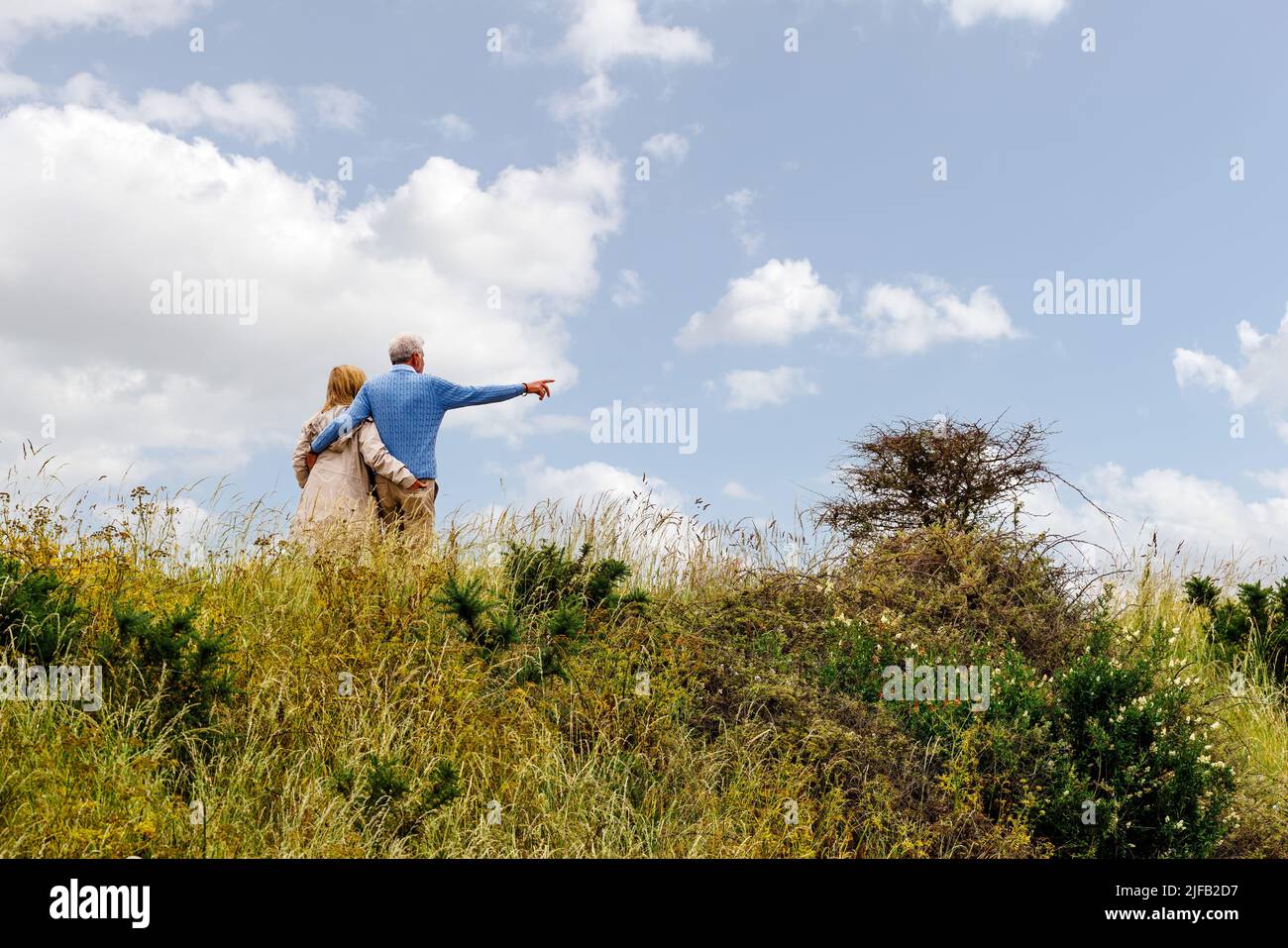 Loving Elderly couple walking at Lymington and Keyhaven Marshes Nature Reserve on a summers day Stock Photo