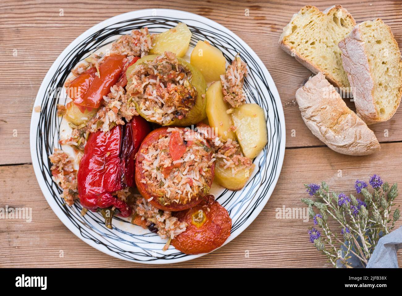Greek summer food, gemista. stuffed tomatoes and peppers with rice, onion, minced meat, cooked in the oven. tasty and light food. Stock Photo