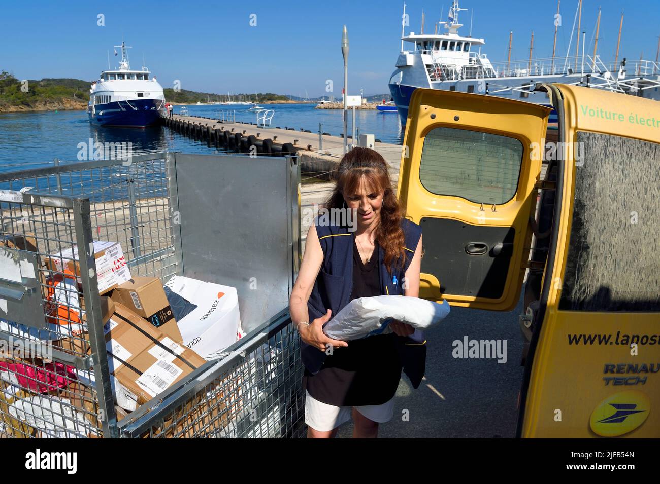 France, Var, Iles d'Hyeres, Parc National de Port Cros (National park of Port Cros), Porquerolles island, arrival of postwoman Christine Frissong at the port early morning with the mail Stock Photo