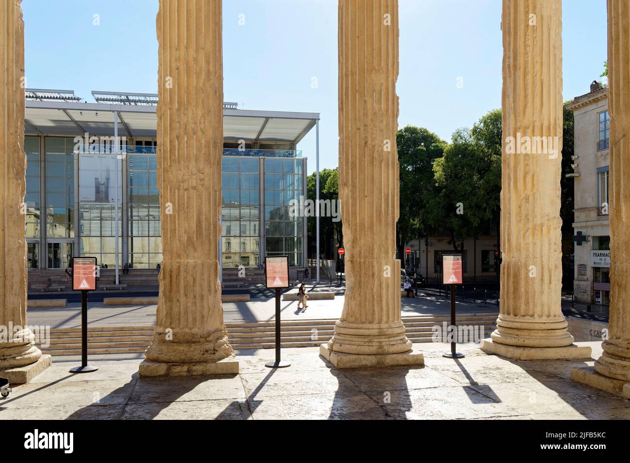 France, Gard, Nimes, Maison Carree, old Roman Temple of the 1st century BC, Contemporary Art museum and Le Carre d'Art by architect Norman Forster, Multimedia Library and Contemporary Art Centre Stock Photo