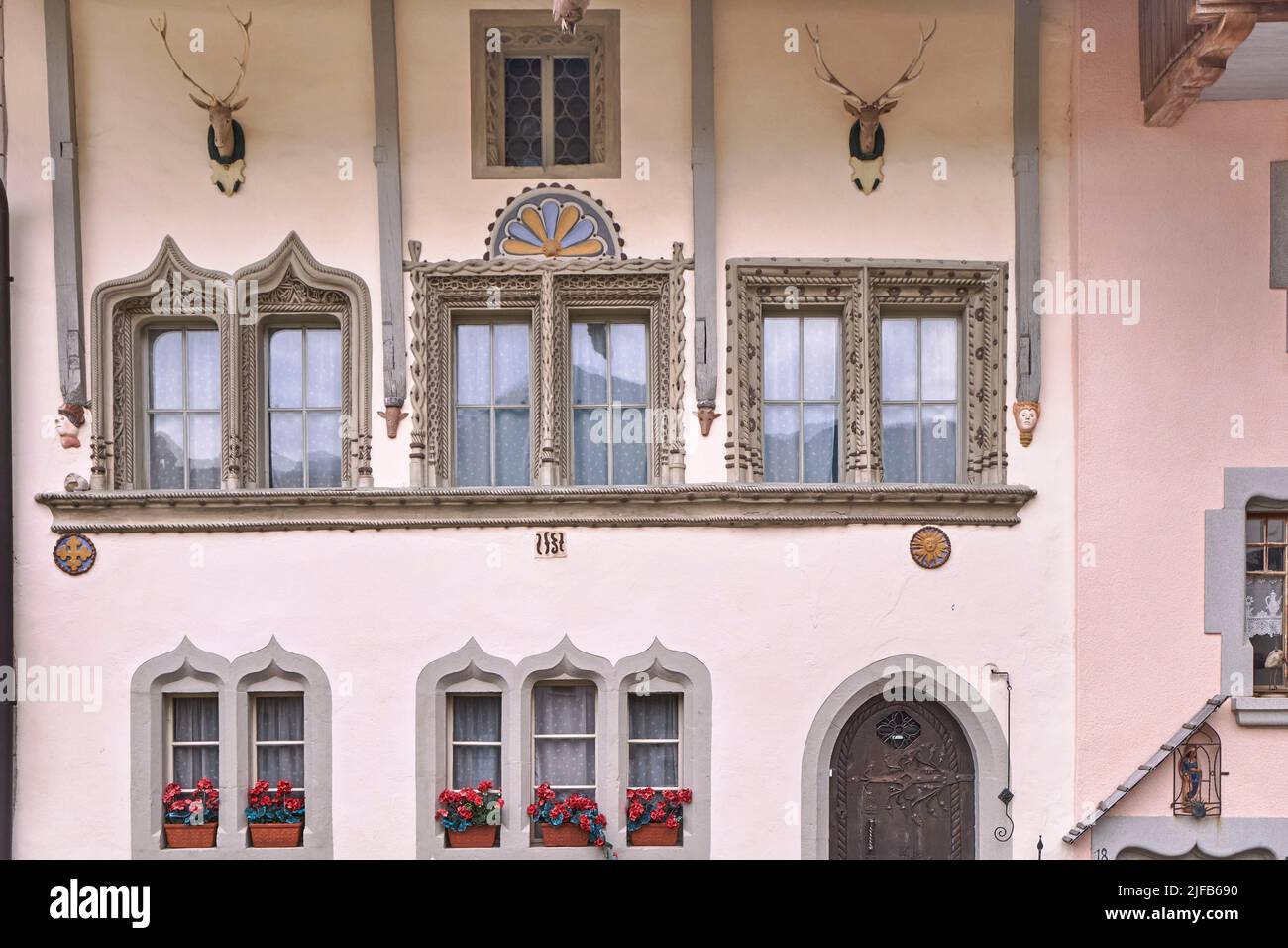 Switzerland, Canton of Friborg, Gruyères, medieval city, house facade with deer trophies Stock Photo