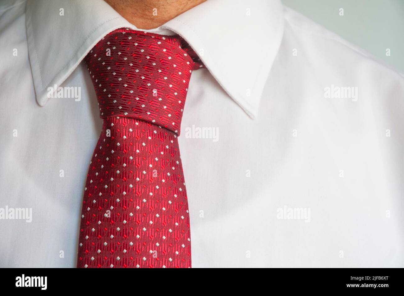 Executive wearing white shirt and red tie. Close view. Stock Photo