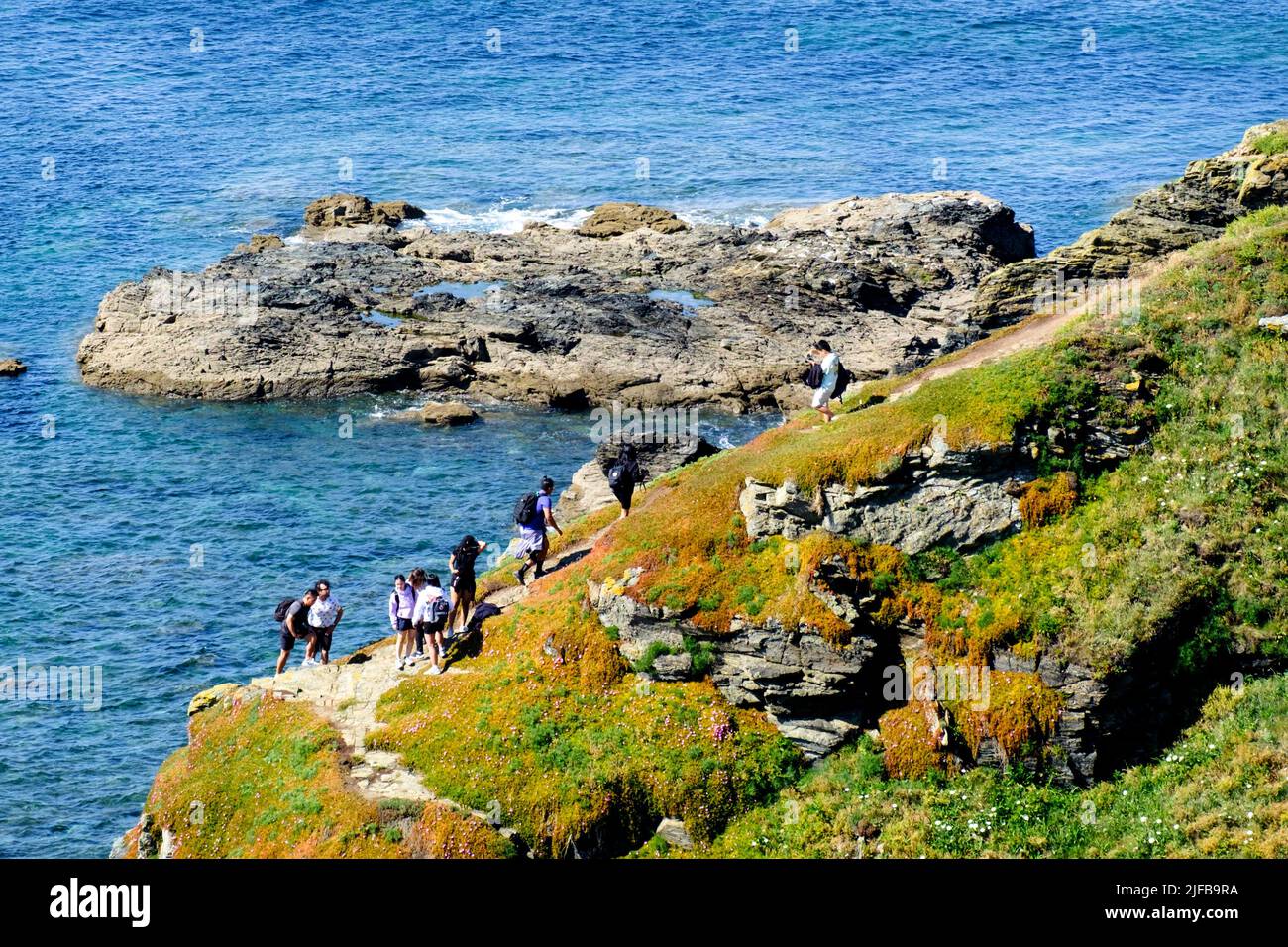 Visitors enjoy the Cliffs at the most southerly point on the Lizard Peninsula Cornwall UK Stock Photo