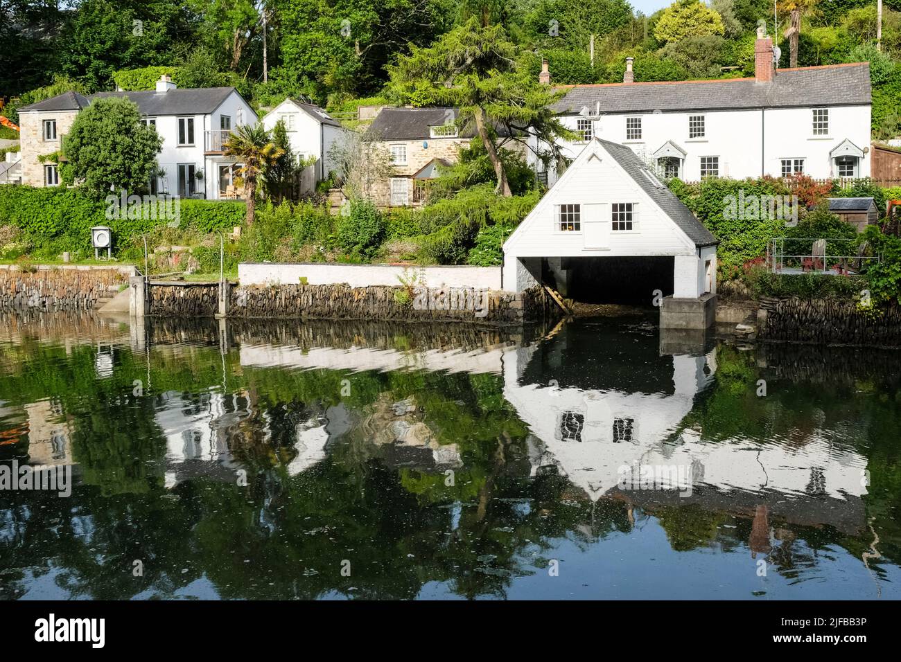 Boathouse and reflection. Helford in Cornwall UK Stock Photo