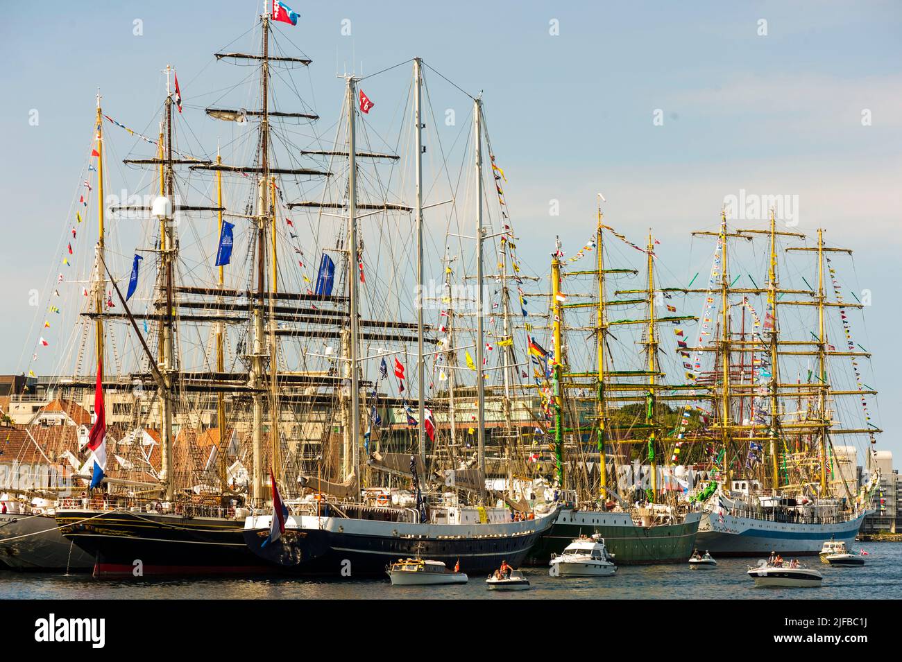 Norway, Rogaland County, Stavanger, gathering of old rigs in front of historic port warehouses for the Tall Ships Races Stock Photo