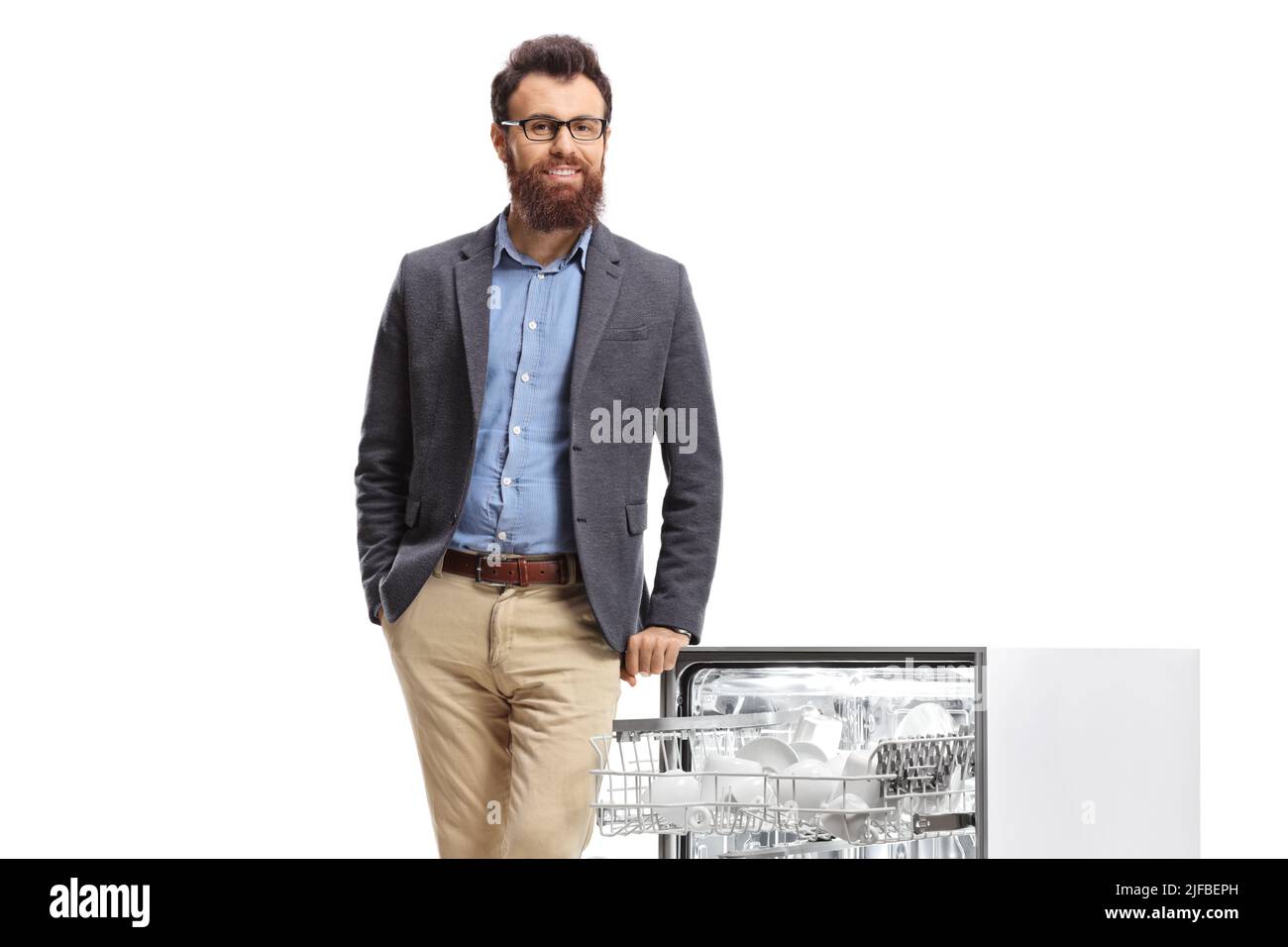 Bearded man leaning on an open dishwasher isolated on white background Stock Photo