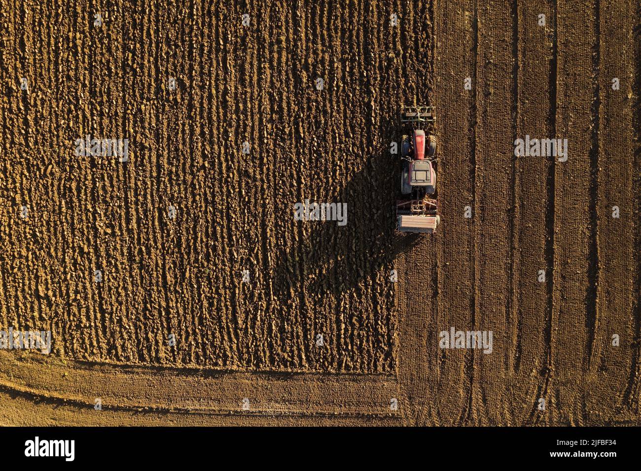 France, Var, Brue Auriac, the plain of Saint Esteve, tractor turning the earth (aerial view) Stock Photo