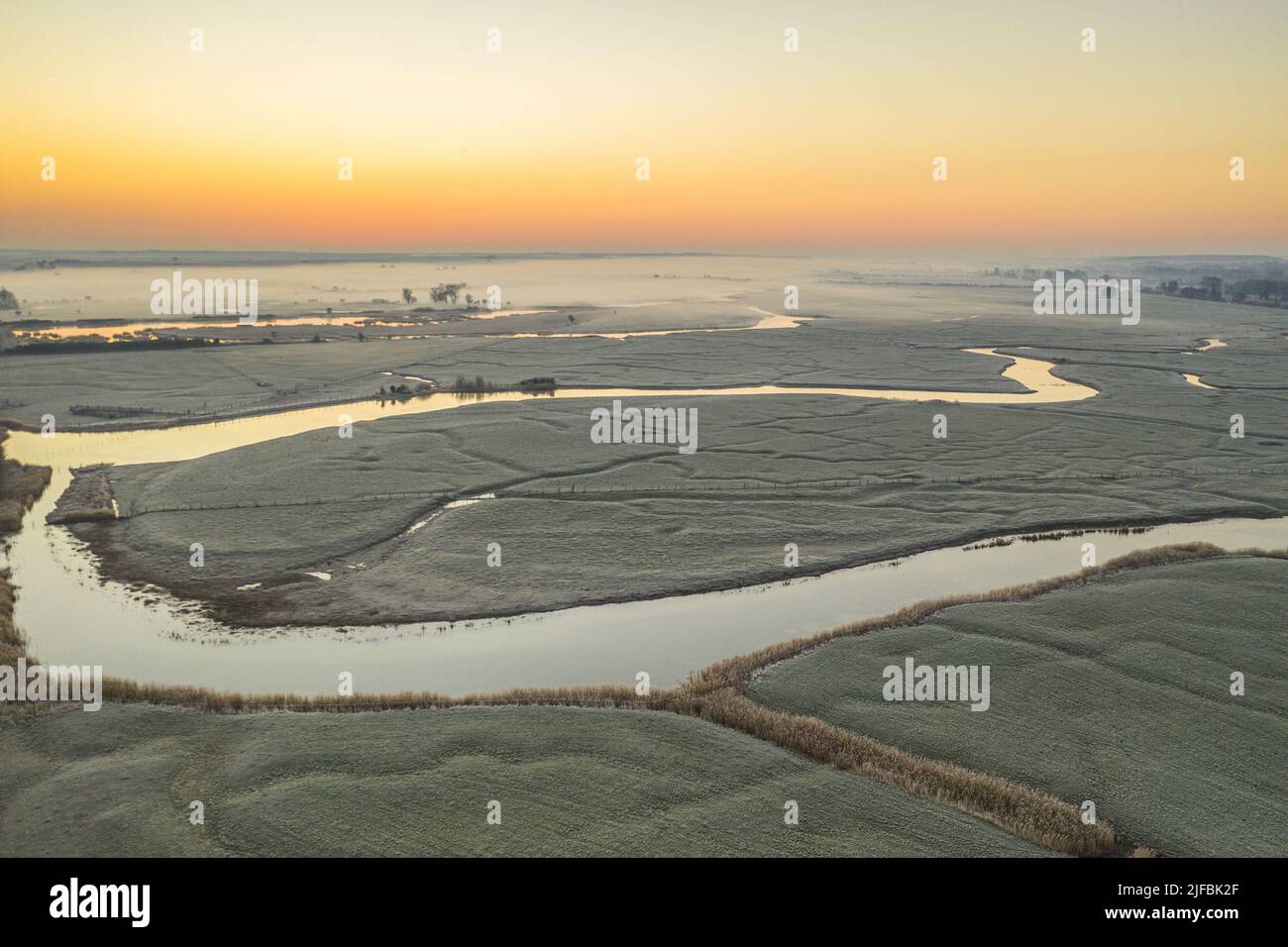 France, Somme, Somme Bay, Saint-Valery-sur-Somme, Sunrise over frozen polders on a winter morning (aerial view) Stock Photo