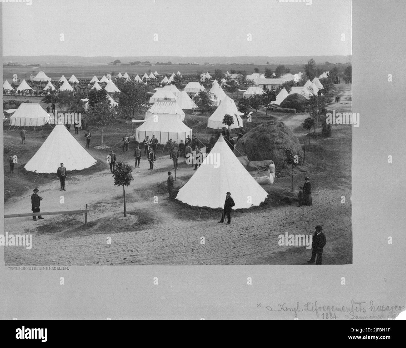 Soldiers from the Life Regiment's Husars K 3 stand outside tent camps at Sanna Hed. Outside some tents are large hay bales. Civil people are visiting the camp. Soldiers from the Life Regiment's Husars K 3 stand outside tent camps at Sanna Hed. Outside some tents are large hay bales. Civil people are visiting the camp. Stock Photo