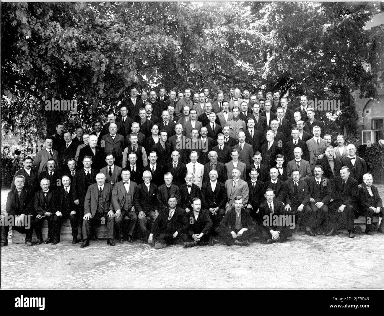 Group portrait of men in front of the eastern part of the fabric house ...
