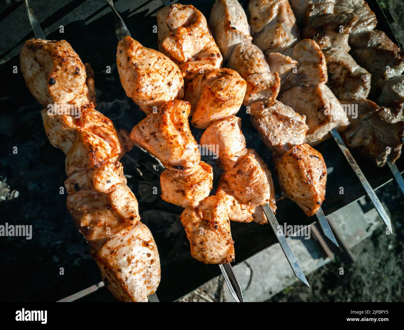 Meat skewers on skewers. Cooking on charcoal grill Stock Photo - Alamy