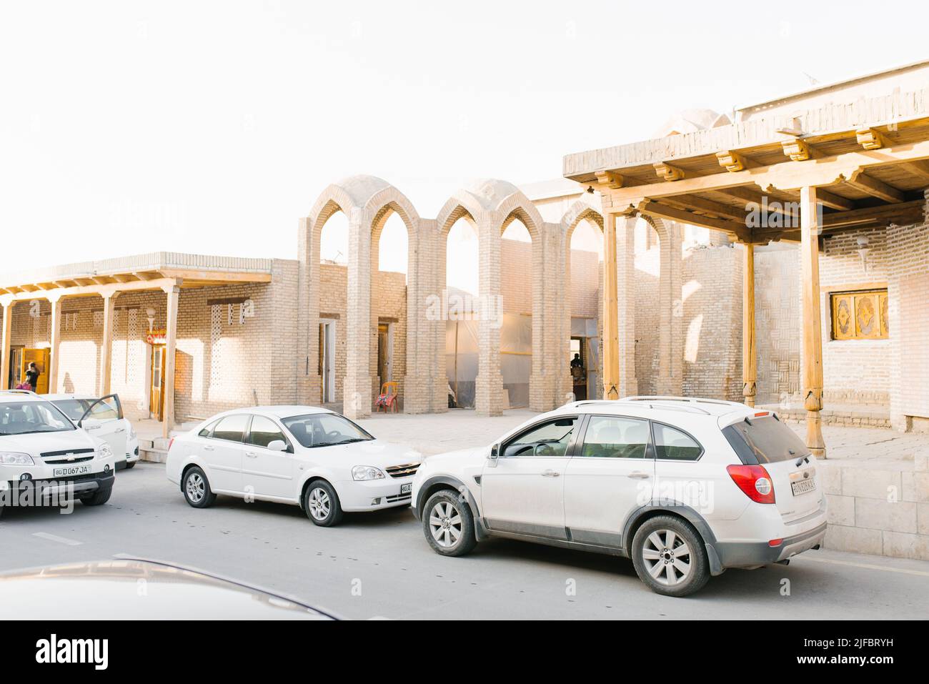 Bukhara, Uzbekistan. March 2022. White passenger cars on the streets of