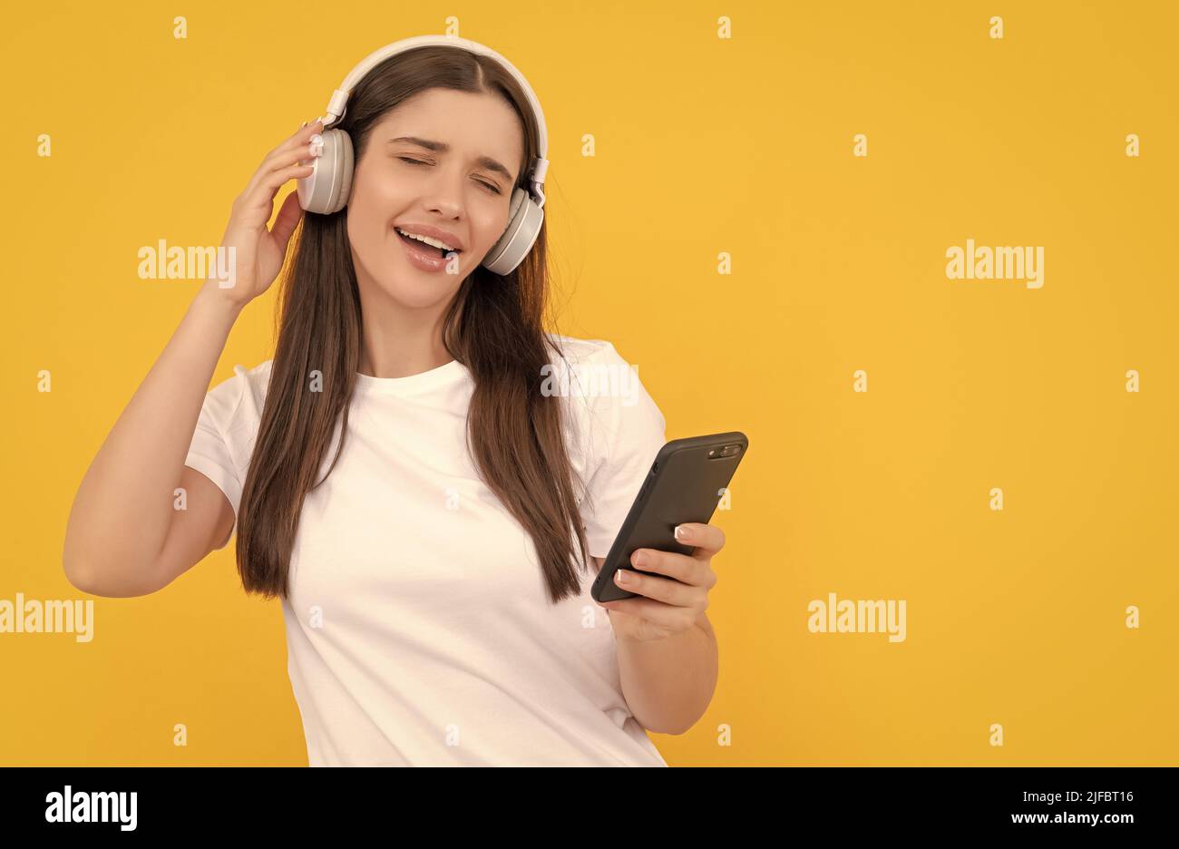 communication technology. woman chat on smartphone. listening to music ...