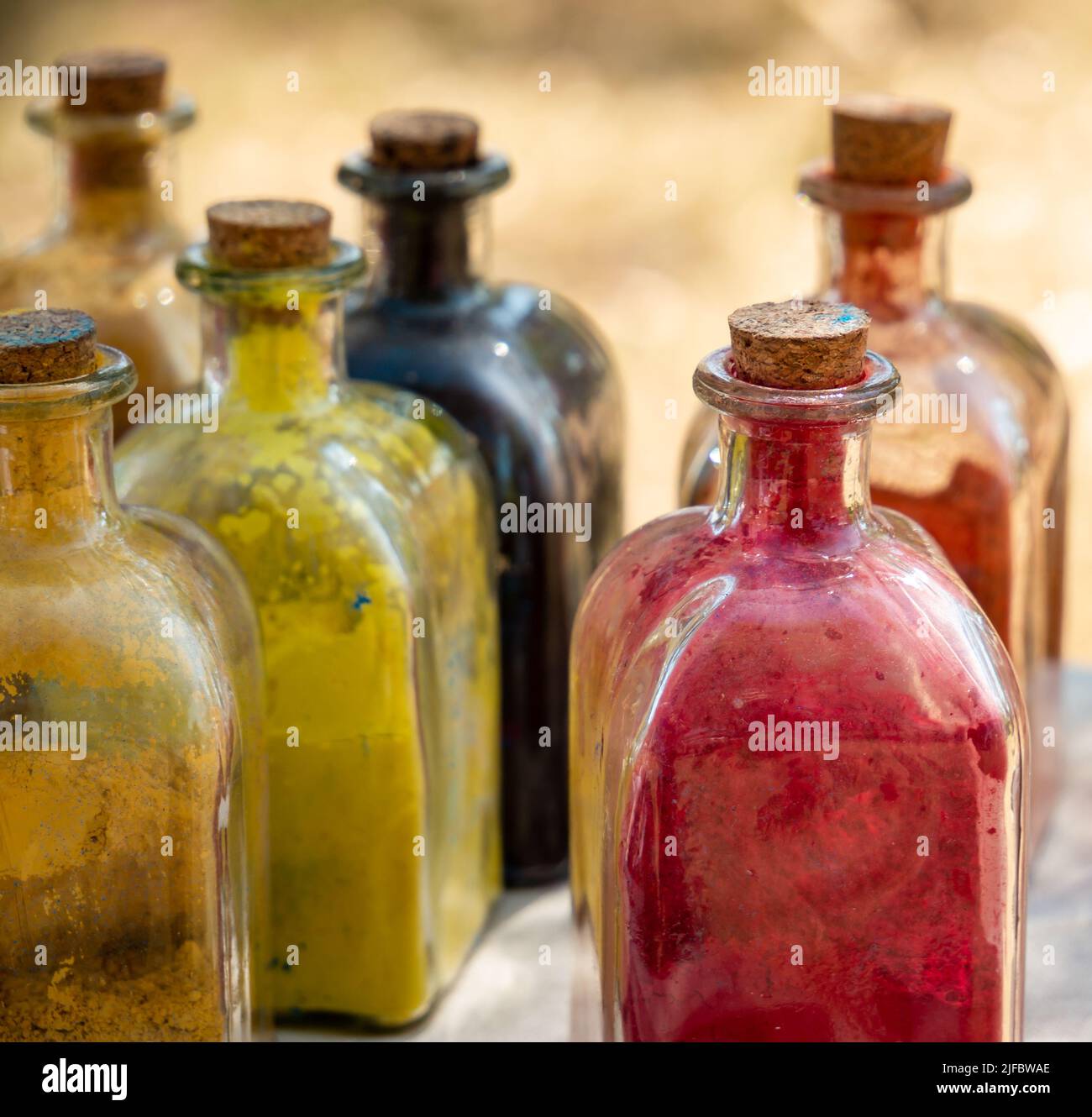 medieval historical reenactment - glass bottles with cork stopper with powder colors inside used to paint or to color clothes and leather Stock Photo