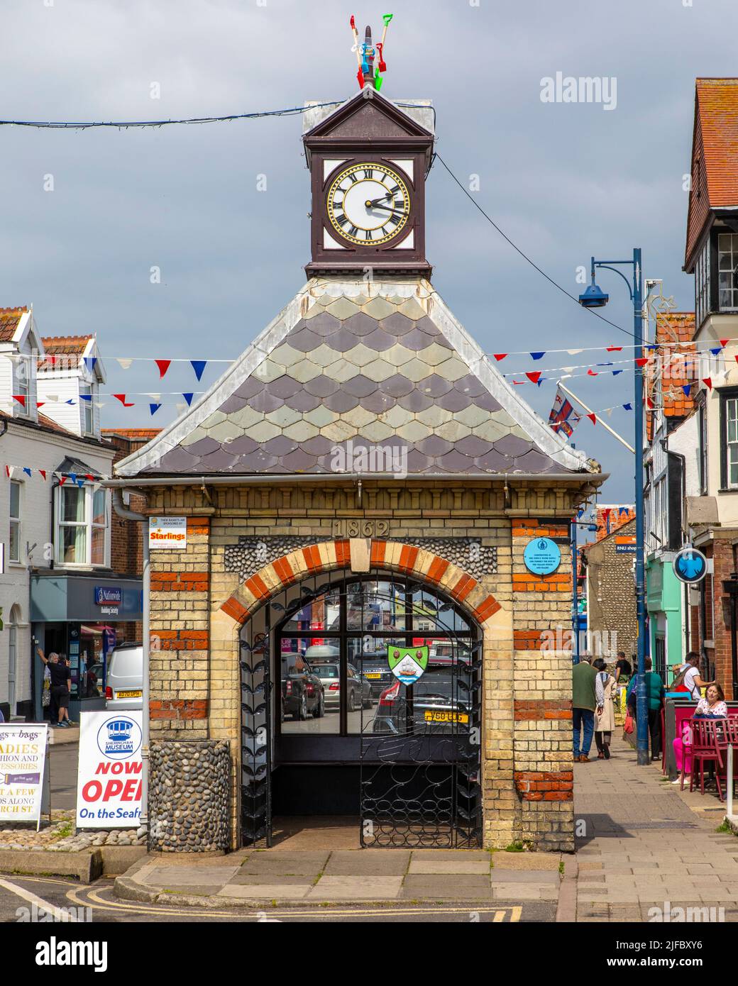 Sheringham, UK - May 16th 2022: Clock tower in the seaside town of Sheringham in Norfolk, UK. The construction was originally a water pump which suppl Stock Photo