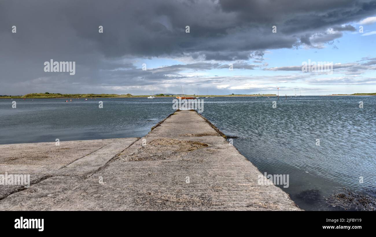 An old jetty points out into the sea at Malahide Stock Photo