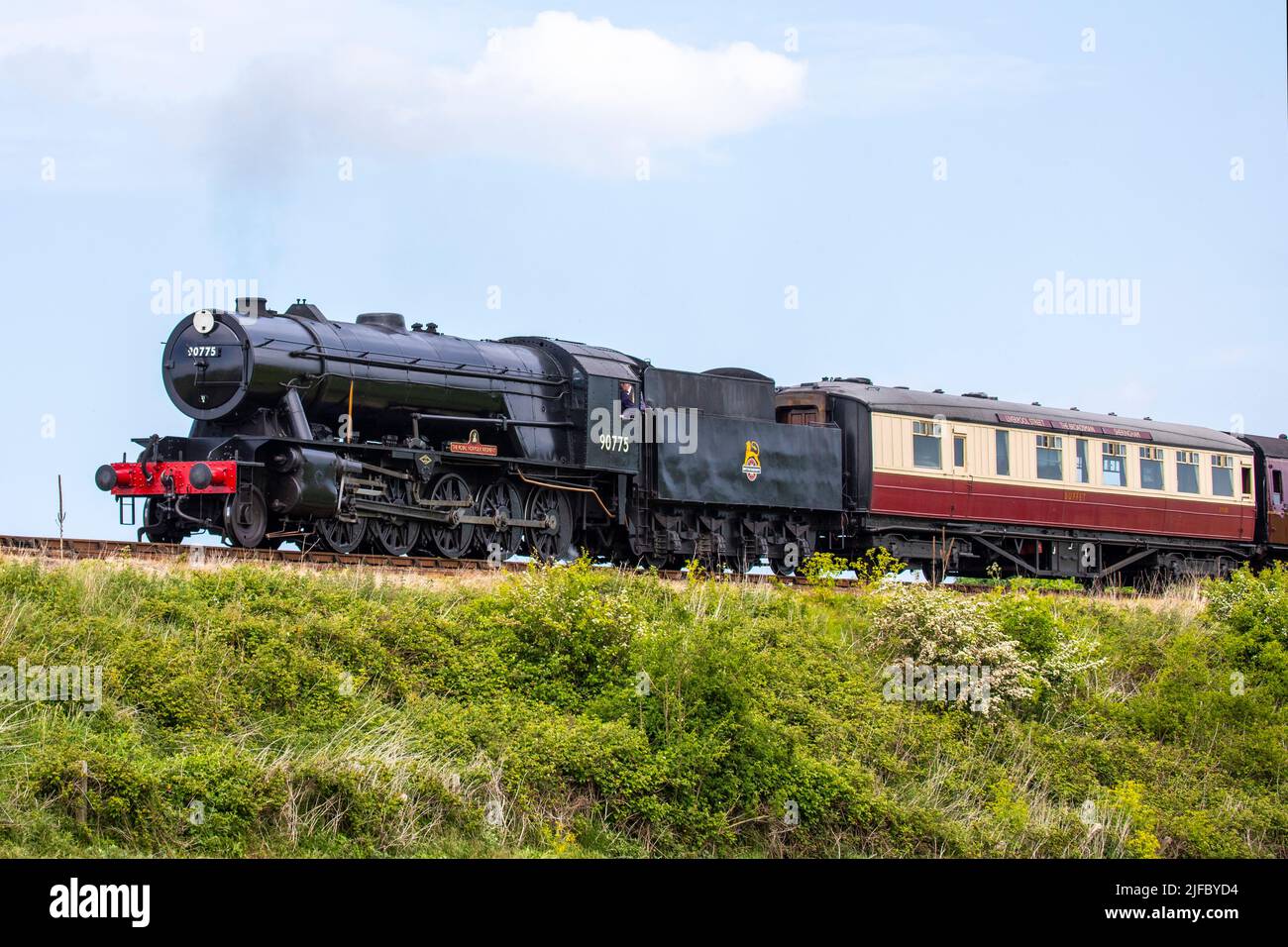 Sheringham, UK - May 16th 2022: A steam train running on the North Norfolk Railway line, also known as the Poppy Line, pictured near the town of Sheri Stock Photo
