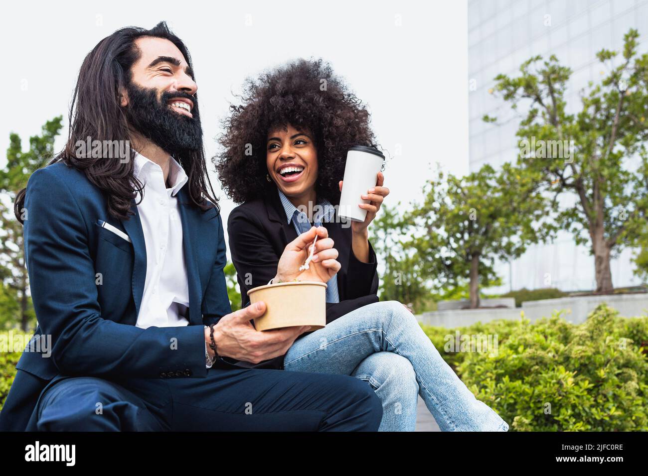Happy multiracial business people having a lunch break outside office Stock Photo