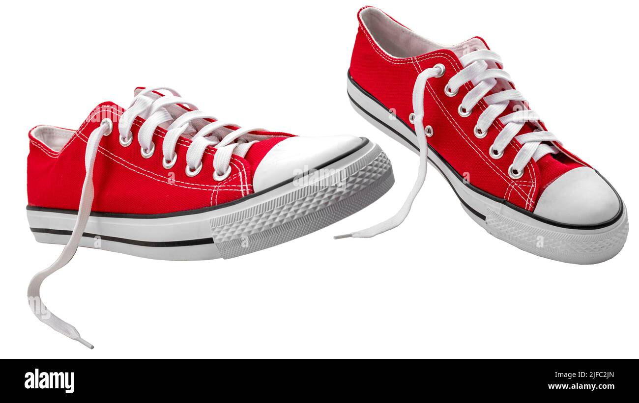 Vivid red vintage canvas sports shoes with laces, suitable for playing basketball, tennis or running, isolated on white with clipping path cutout conc Stock Photo