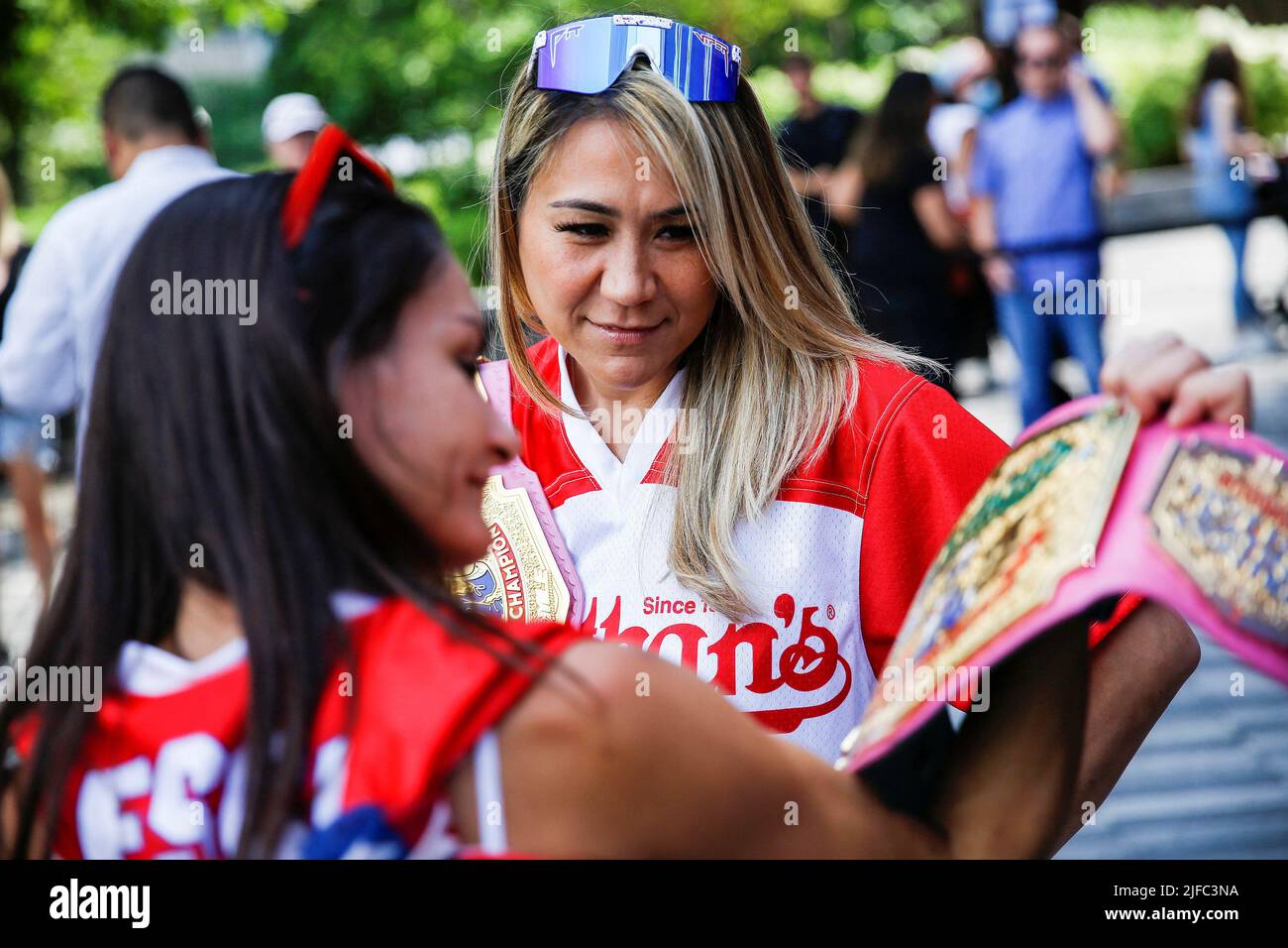 World Champion Miki Sudo looks at the 2021 Women World Championship belt of  Michelle Lesco before being weigh-in ahead of Nathan's Famous Fourth of  July International Hot Dog-Eating Contest in New York,