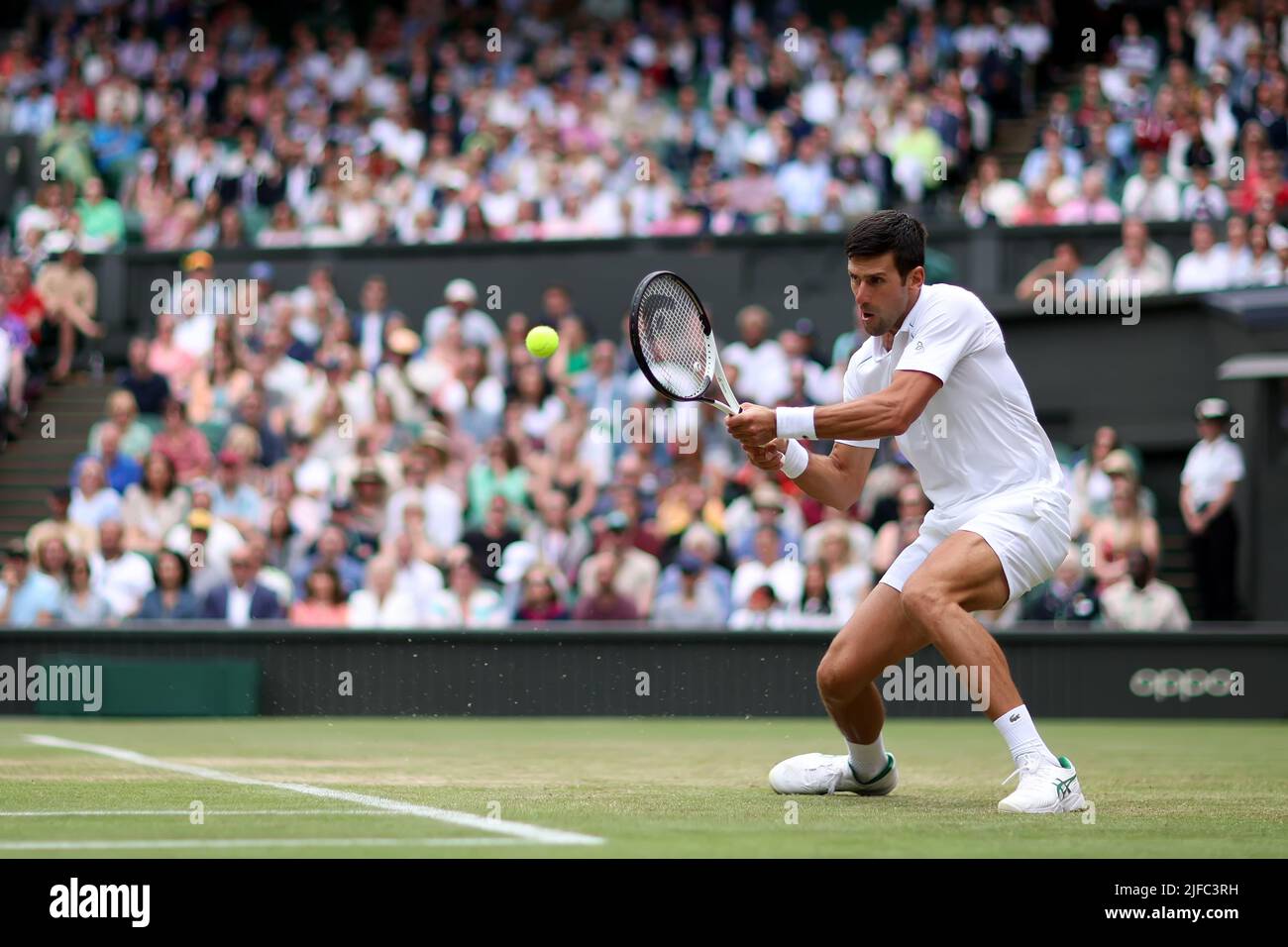 London, UK. 01st July, 2022. 1st July 2022, All England Lawn Tennis and Croquet Club, London, England; Wimbledon Tennis tournament; Novak Djokovic plays a backhand to Miomir Kecmanovic in the mens singles Credit: Action Plus Sports Images/Alamy Live News Stock Photo