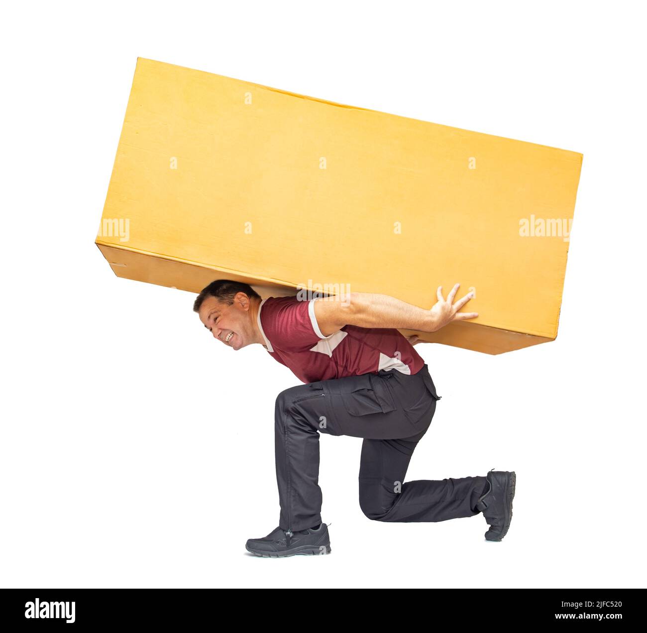 The courier falls under the weight of a large package, isolated on a white background. Stock Photo