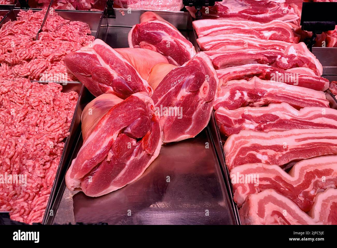 Quality various fresh raw pork meat in fridge showcase at modern butcher  shop. Meat counter. Close-up Stock Photo - Alamy