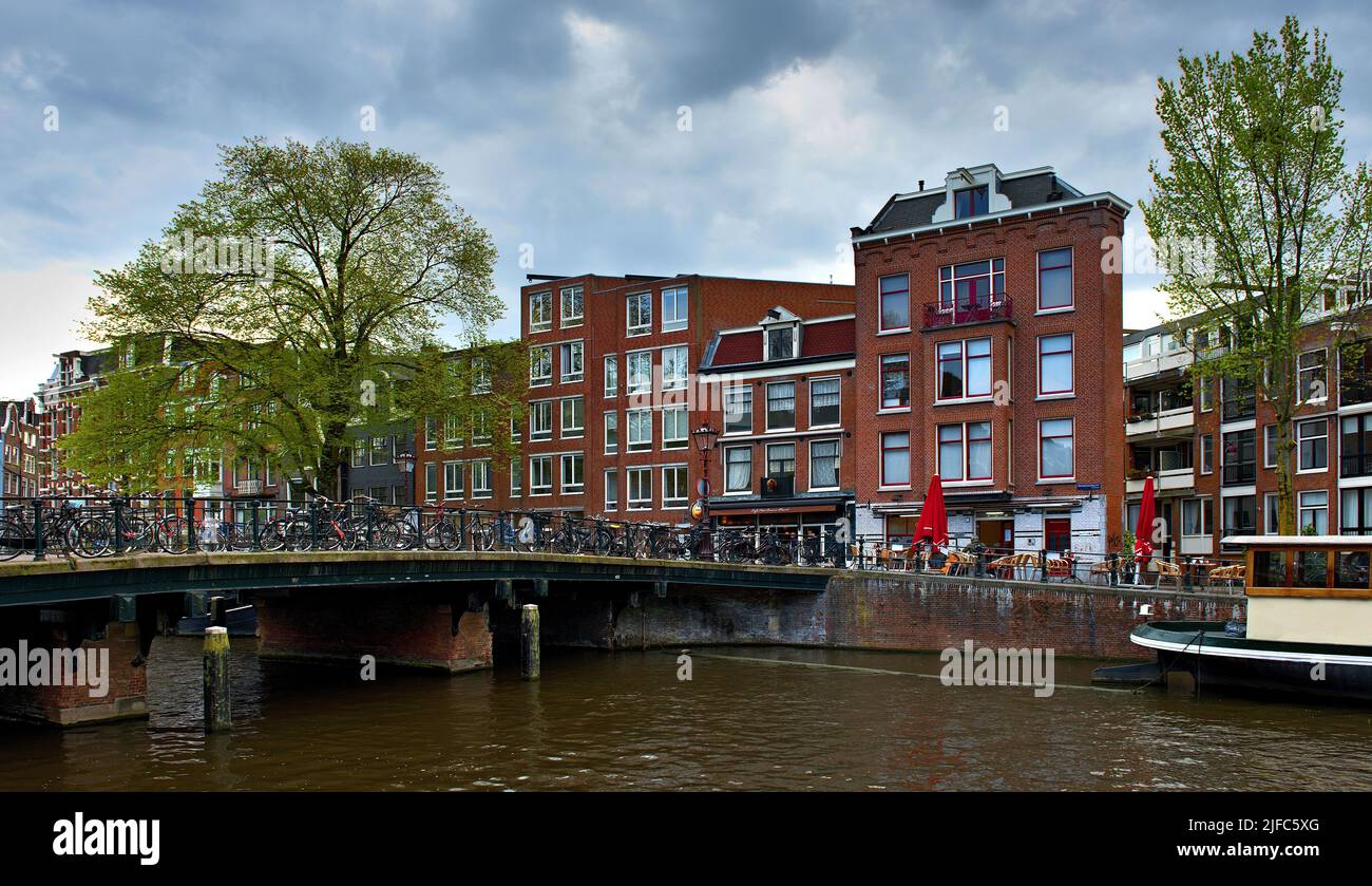 Amsterdam in spring under cloudy sky Stock Photo
