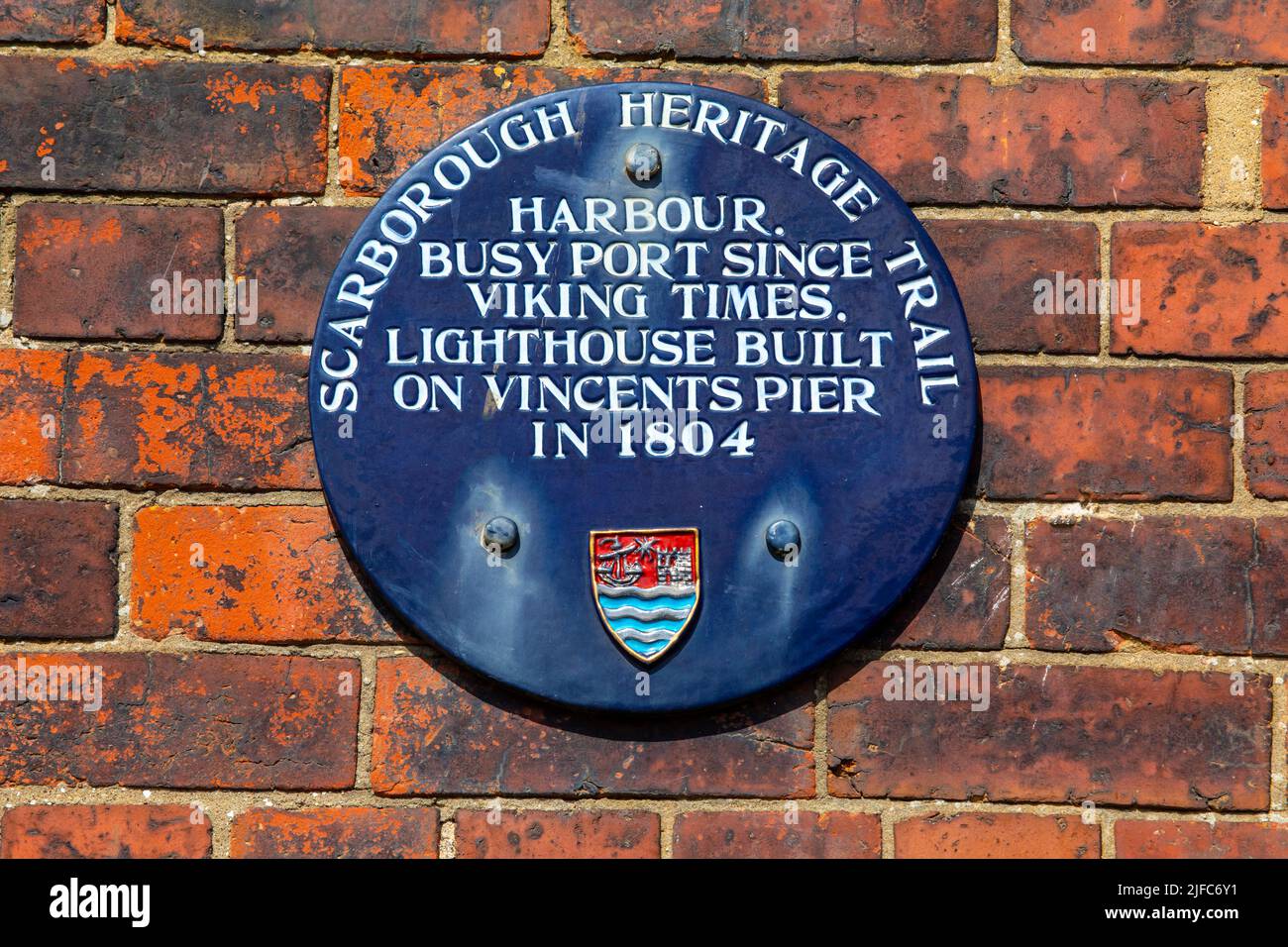 Scarborough, UK - June 8th 2022: A plaque detailing the history of the harbour and lighthouse in the seaside town of Scarborough in North Yorkshire, U Stock Photo