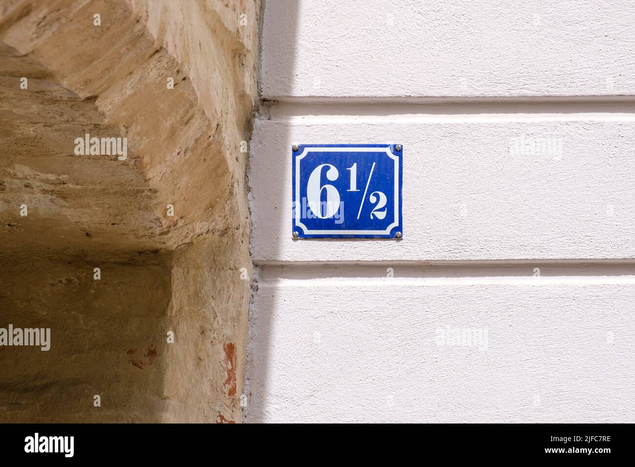 House number 6 1/2 (six and a half), a curiosity for some, but fractional house numbers actually exist. Stock Photo