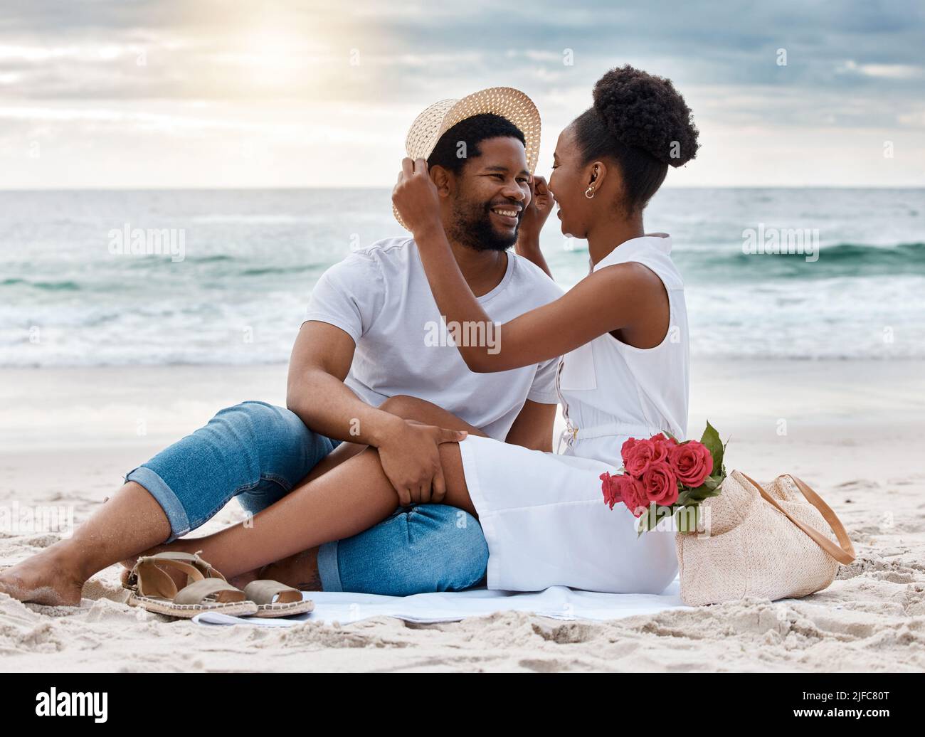 Cheerful african American couple spending a day at the sea together ...
