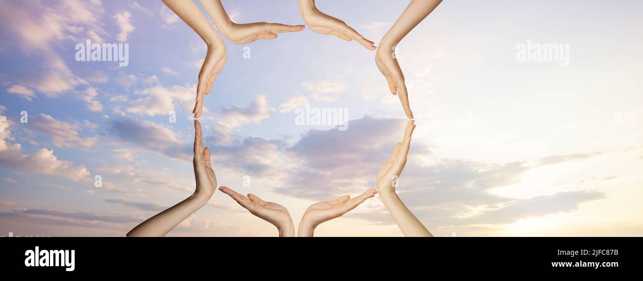 Hands on sky clouds. Unity,  support and togetherness concept Stock Photo