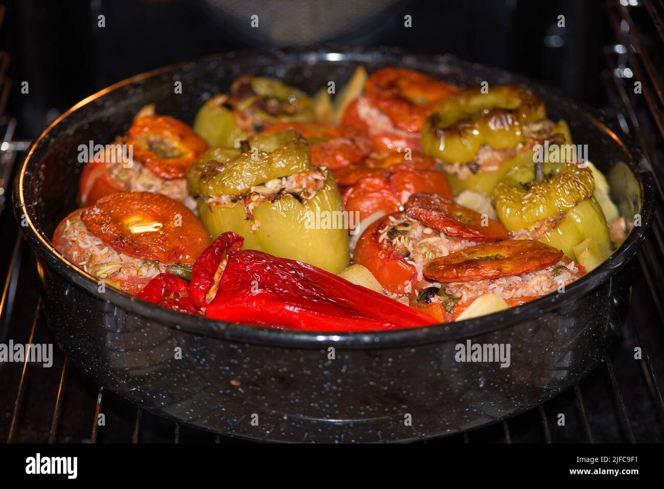 Greek summer food, gemista. stuffed tomatoes and peppers with rice, onion, minced meat, cooked in the oven. tasty and light food. Stock Photo