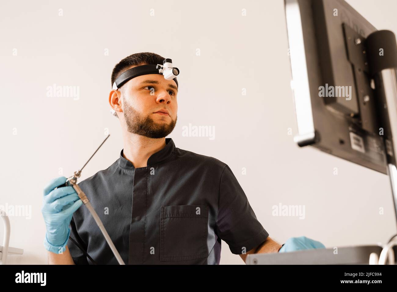 ENT doctor otolaryngologist with endoscope in hands. Prepearing for