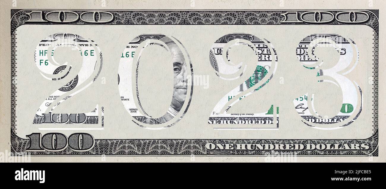 The inscription 2023 made of 100 dollar banknote on 100 dollar banknote