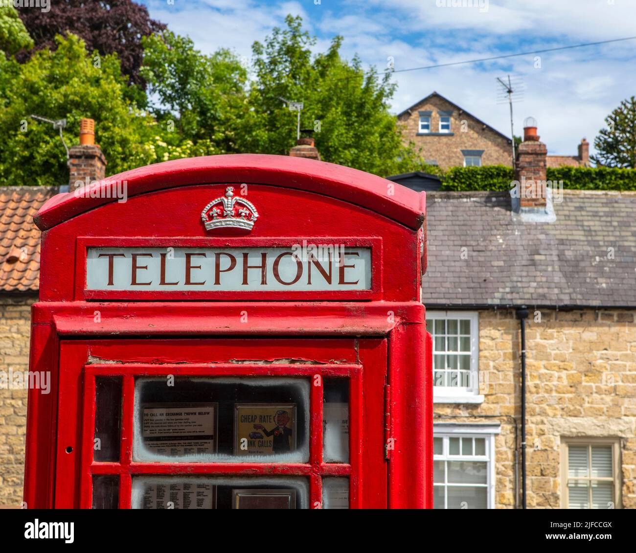 Pickering, UK - June 9th 2022: A traditional red telephone box on the platform at Pickering Railway Station in the town of Pickering in North Yorkshir Stock Photo