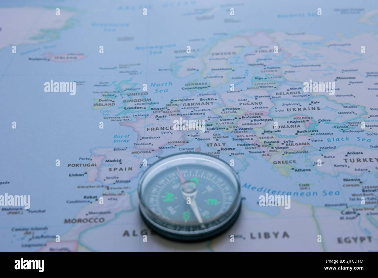 Travel to Europe concept photo. A compass on the Europe map in focus