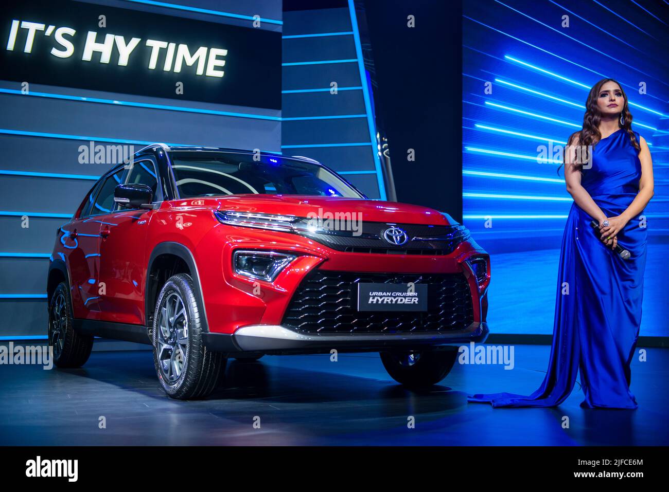 An anchor standing next to the vehicle during the launch. Toyota unveiled the new Urban Cruiser Hyryder at Hyatt Aerocity, Toyota’s first Self-charging Strong Hybrid Electric SUV and the first of its kind, in the B SUV segment in India. Stock Photo