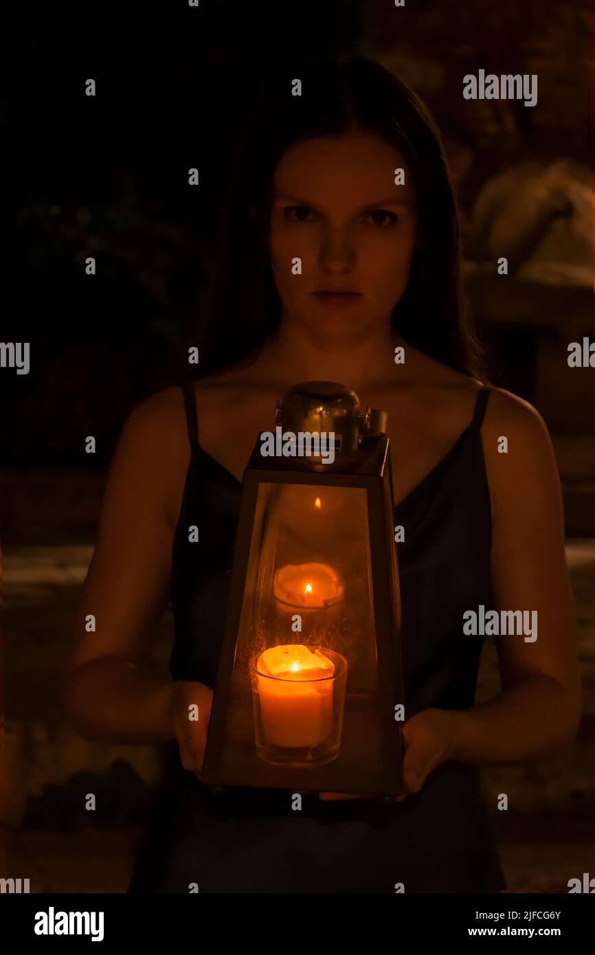 Dark scary woman with a lantern at night Stock Photo - Alamy