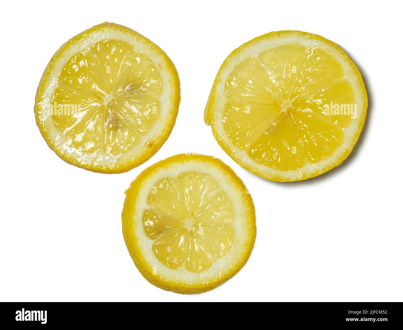 A sliced lemon   on a white background. Citrus on the table. Bright background. Healthy fortified food for a diet. sour product. Stock Photo