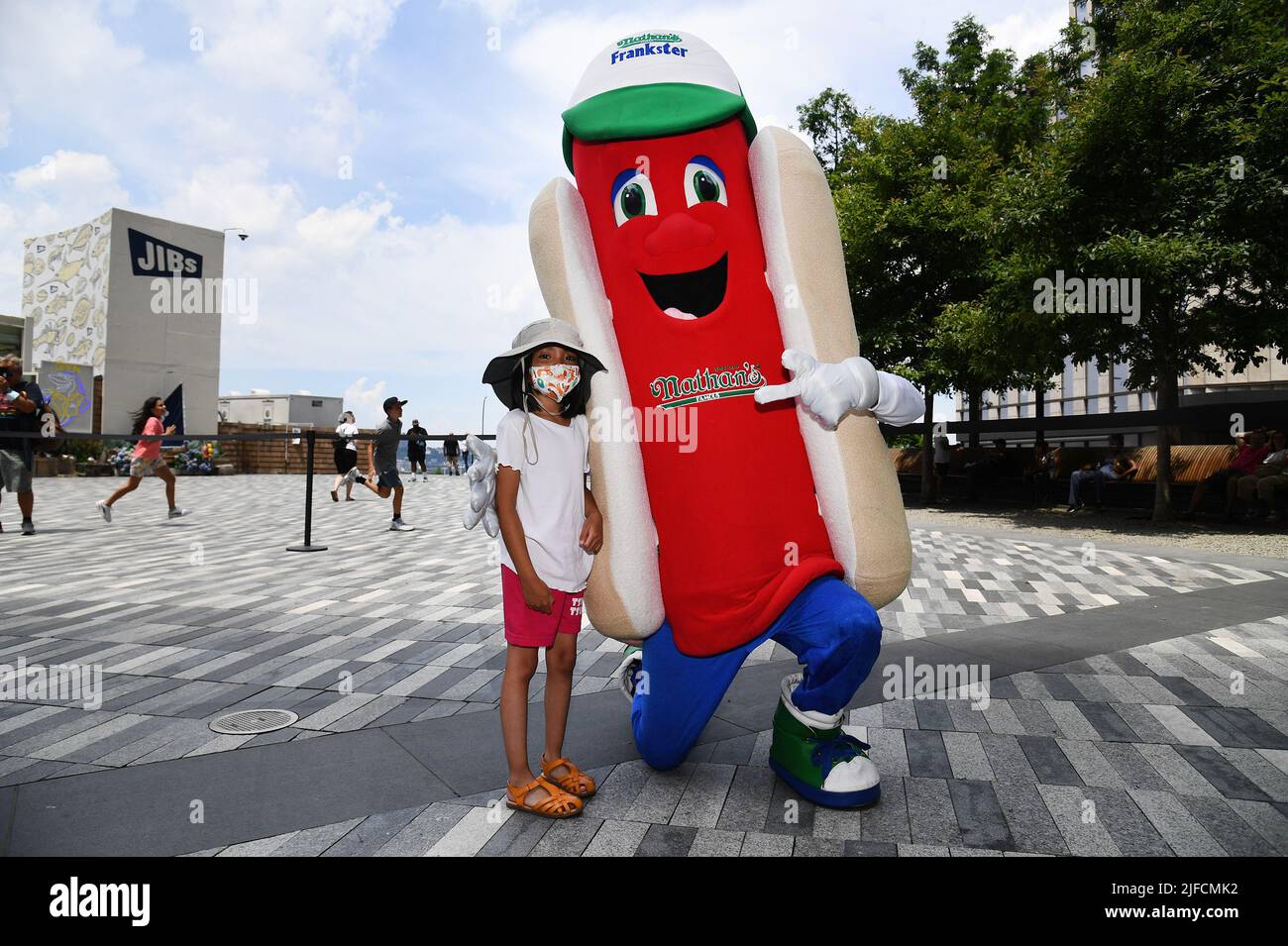 New York, USA. 01st July, 2022. A young girl poses with Frankster the hot dog mascot at the official weigh in ceremony for Nathan's Famous Fourth of July International Hot Dog Eating Championship, at Hudson Yards, New York, NY, July 1, 2022. (Photo by Anthony Behar/Sipa USA) Credit: Sipa USA/Alamy Live News Stock Photo