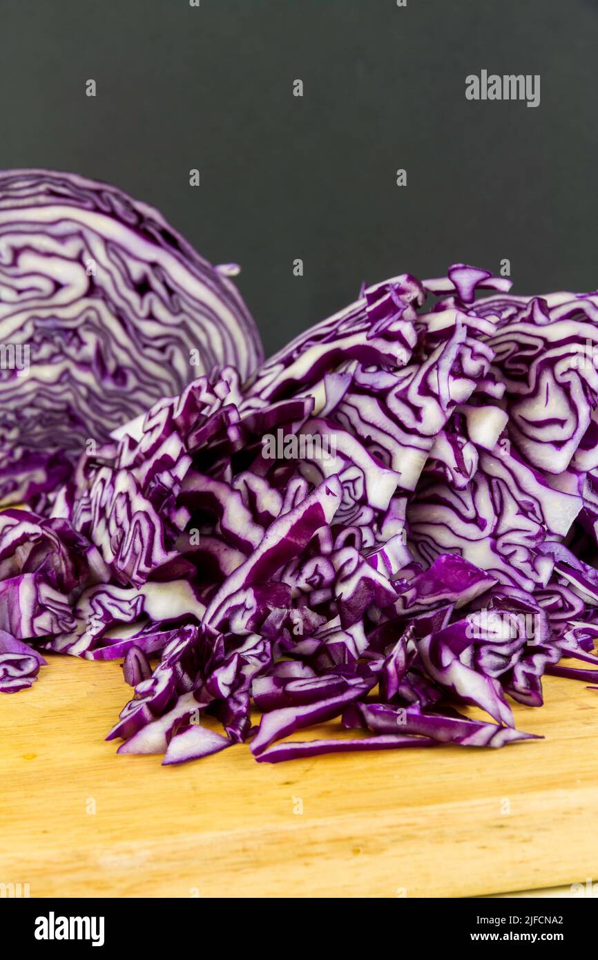 Shredded red cabbage on a  chopping board portrait. Stock Photo