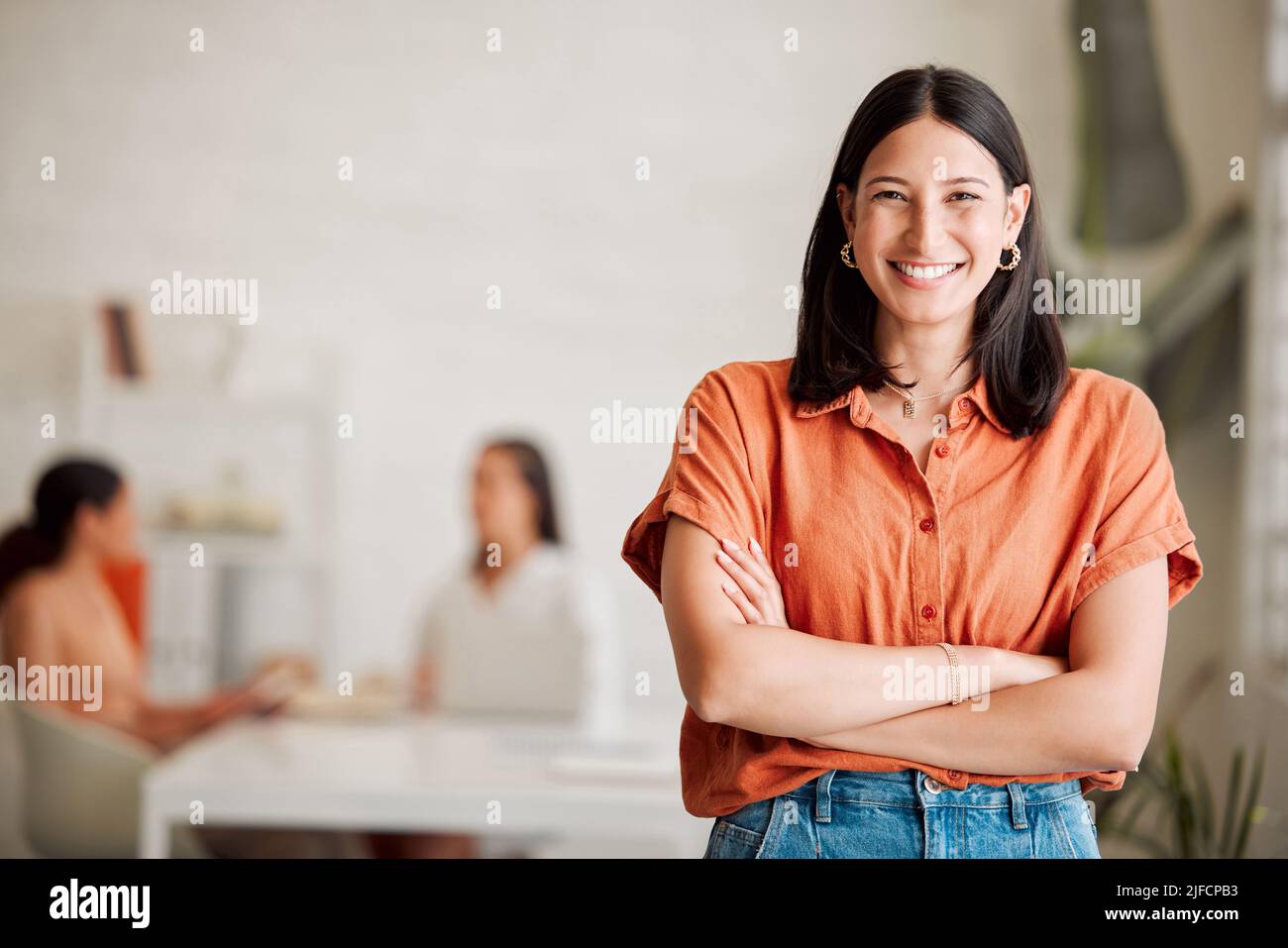 Portrait of one confident young hispanic business woman standing with ...