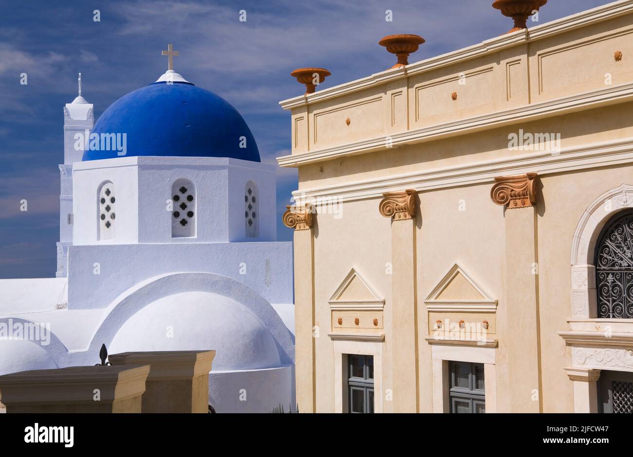 Restored old architectural hotel building and blue domed chapel, Pyrgos, Santorini, Greece. Stock Photo