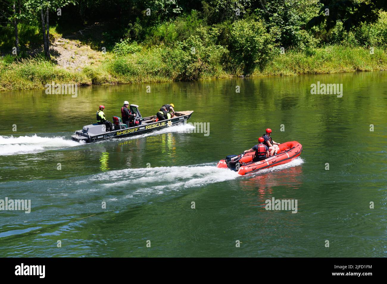 Fall City, WA, USA - July 01, 2022; King County Sheriff Rescue police boat and Eastside Fire Rescue boat on the Snoqualmie River in Washington State Stock Photo