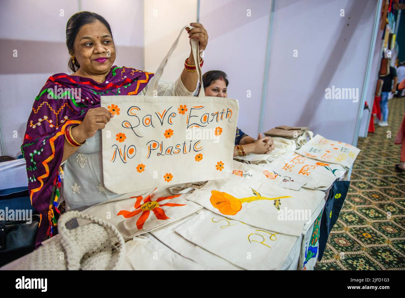 New Delhi, India. 01st July, 2022. Self Help Group member holds a cloth bag during the 'Plastic Vikalp Mela' (alternative to plastic fair) to spread awareness about replacement of plastic products at the Thyagraj Stadium. Centre Government bans the manufacture, import, stocking, distribution, sale, and use of identified single-use plastic items with low utility and high littering potential from July 1, 2022 in India. Credit: SOPA Images Limited/Alamy Live News Stock Photo